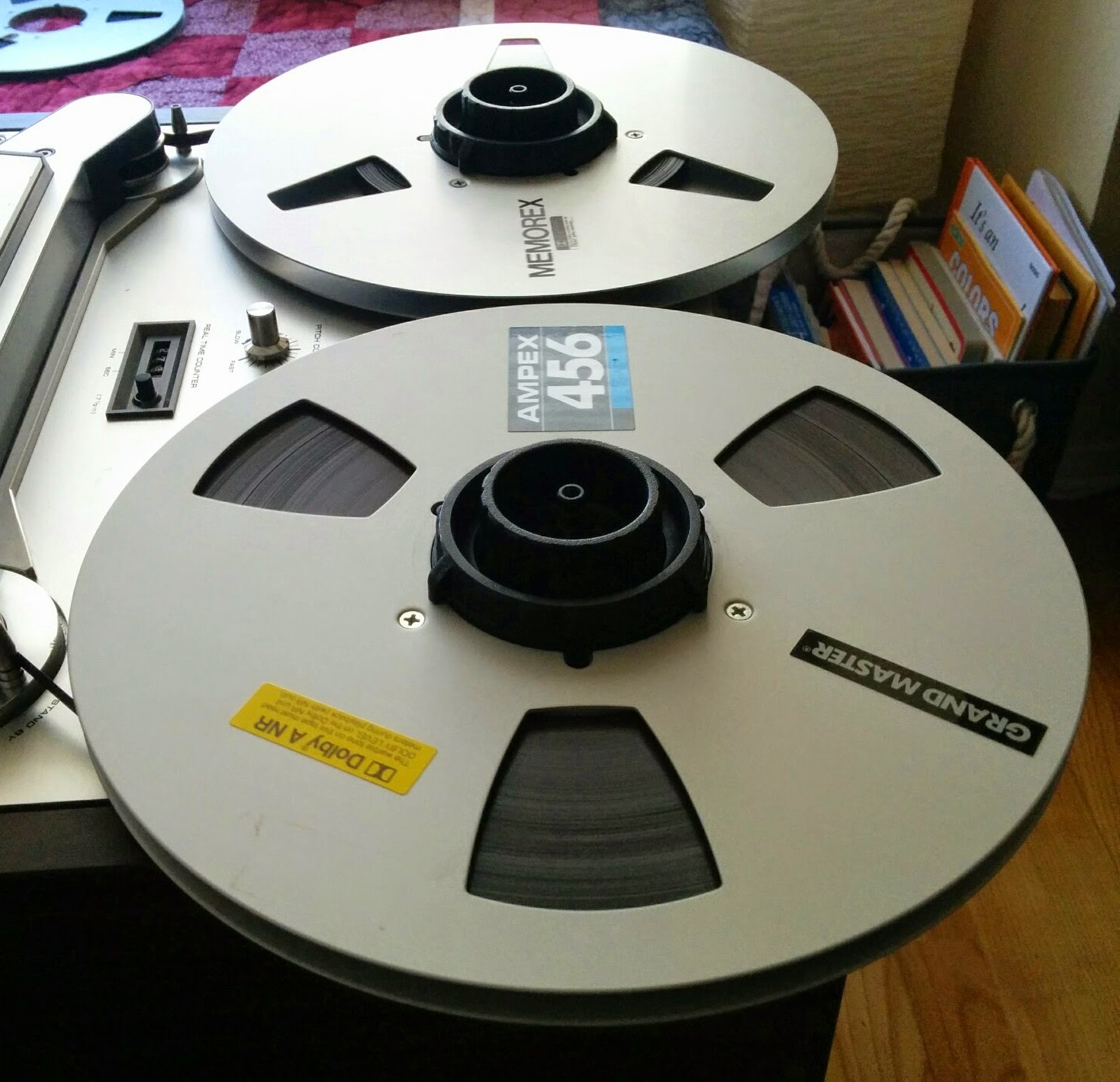 Two ten-inch reels of magnetic tape on a reel-to-reel recorder