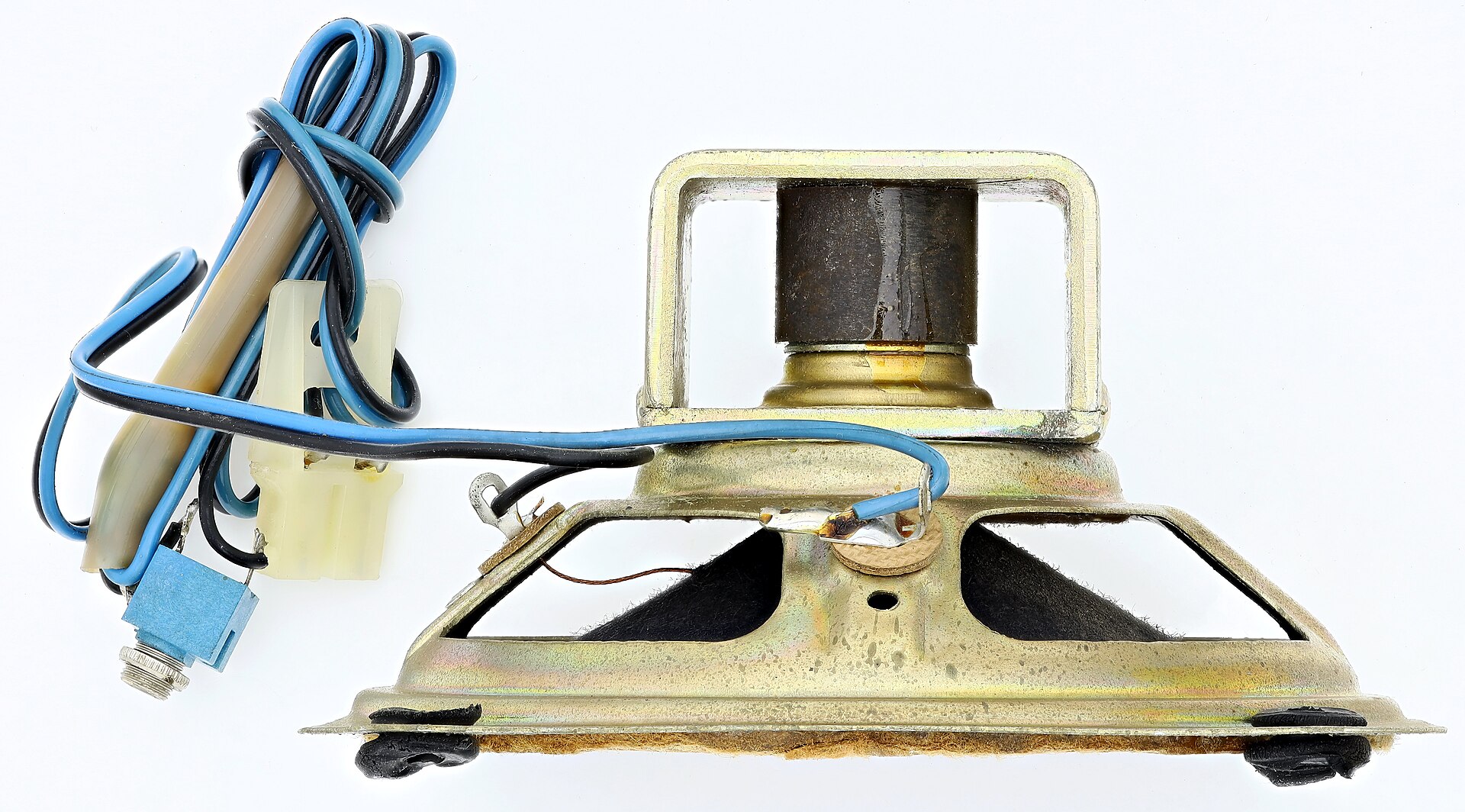 A small loudspeaker from the side, with its magnet, metal frame, cone and connecting wires
